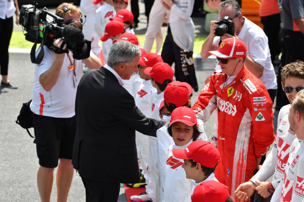 Chase Carey, Chief Executive Officer and Executive Chairman of the Formula One Group and Kimi Raikkonen, Ferrari on the grid