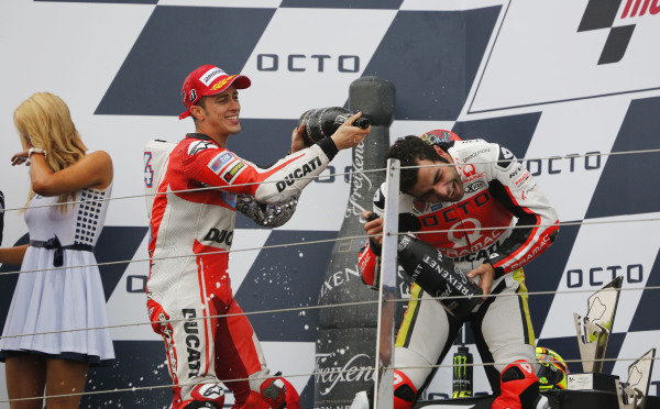 2015 MotoGP Championship. 
British Grand Prix. 
Silverstone, England. 28th - 30th August 2015. 
Danilo Petrucci, Pramac Ducati, 2nd position, and Andrea Dovizioso, Ducati, 3rd position, celebrate on the podium. 
Ref: KW5_5625a. World copyright: Kevin Wood/LAT Photographic