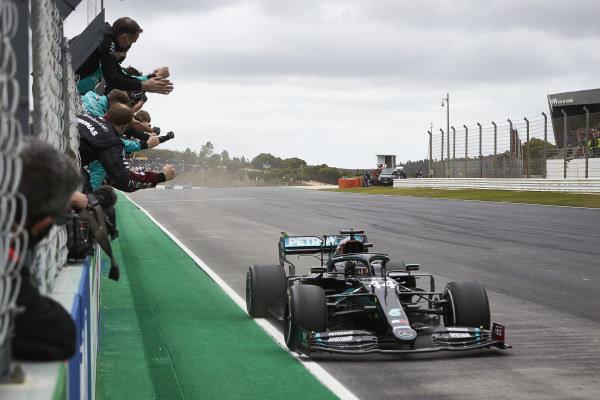 Lewis Hamilton, Mercedes F1 W11 EQ Performance, is greeted by team members as he takes the finish to score a record-breaking 92nd Formula 1 victory