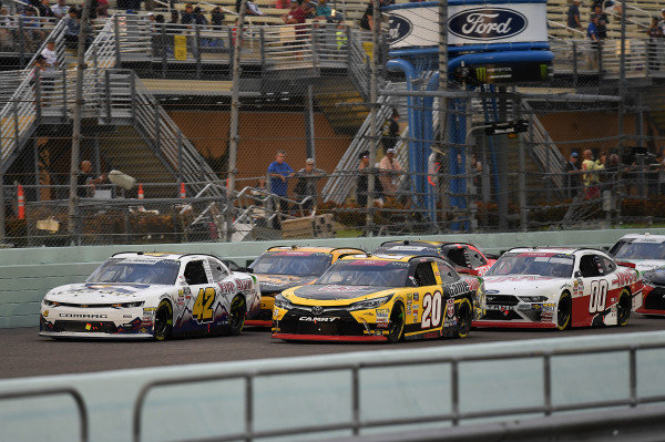 #20: Christopher Bell, Joe Gibbs Racing, Toyota Camry GameStop Transformers, #42: John Hunter Nemechek, Chip Ganassi Racing, Chevrolet Camaro Fire Alarm Services, Inc., and #00: Cole Custer, Stewart-Haas Racing, Ford Mustang Haas Automation