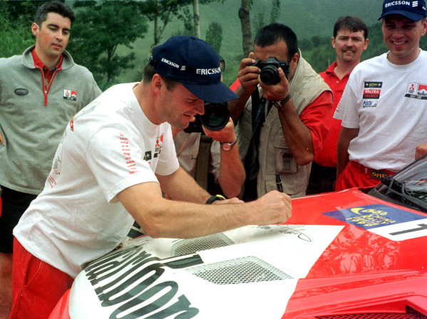 WRC China, Peoples Republic of China. Rd 11 of 14.
Tommi Makinen resigns with Mitsubishi for another two years.
Photo: Ralph Hardwick
Tel: +44 (0)181 251 3000
Fax: +44 (0)181 251 3001
Somerset House, Somerset Road, Teddington, Middlesex,
United Kingdon. TW11 8RU WRC China, Peoples Republic of China. Rd 11 of 14.
Tommi Makinen resigns with Mitsubishi for another two years.
Photo: Ralph Hardwick
Tel: +44 (0)181 251 3000
Fax: +44 (0)181 251 3001
Somerset House, Somerset Road, Teddington, Middlesex,
United Kingdon. TW11 8RU