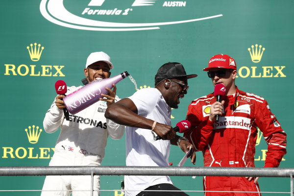 Circuit of the Americas, Austin, Texas, United States of America.
Sunday 22 October 2017.
Lewis Hamilton, Mercedes AMG, 1st Position, pours Champagne on Usain Bolt as he interviews Kimi Raikkonen, Ferrari, 3rd Position.
World Copyright: Glenn Dunbar/LAT Images 
ref: Digital Image _31I5585