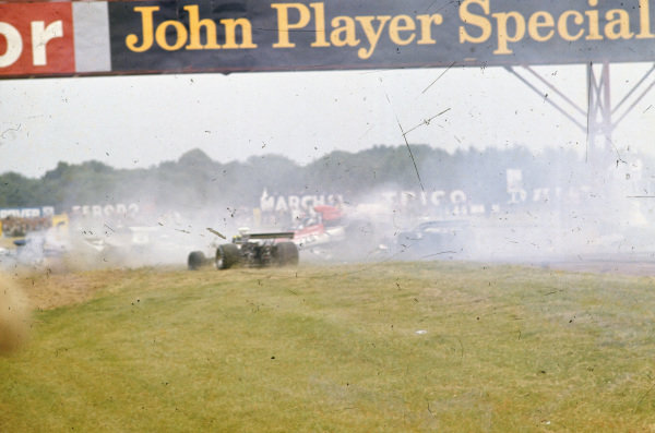 A multi-car pile-up, triggered after Jody Scheckter spun his McLaren M23. Jean-Pierre Beltoise, BRM P160E, is sideways in the middle of the pack with his rear wheels in the air. Wilson Fittipaldi, Brabham BT42 Ford, is to the left of him. On the far left, Carlos Pace crashes his Surtees TS14A Ford. A multi-car pile-up, triggered after Jody Scheckter spun his McLaren M23. Jean-Pierre Beltoise, BRM P160E, is sideways in the middle of the pack with his rear wheels in the air. Wilson Fittipaldi, Brabham BT42 Ford, is to the left of him. On the far left, Carlos Pace crashes his Surtees TS14A Ford.